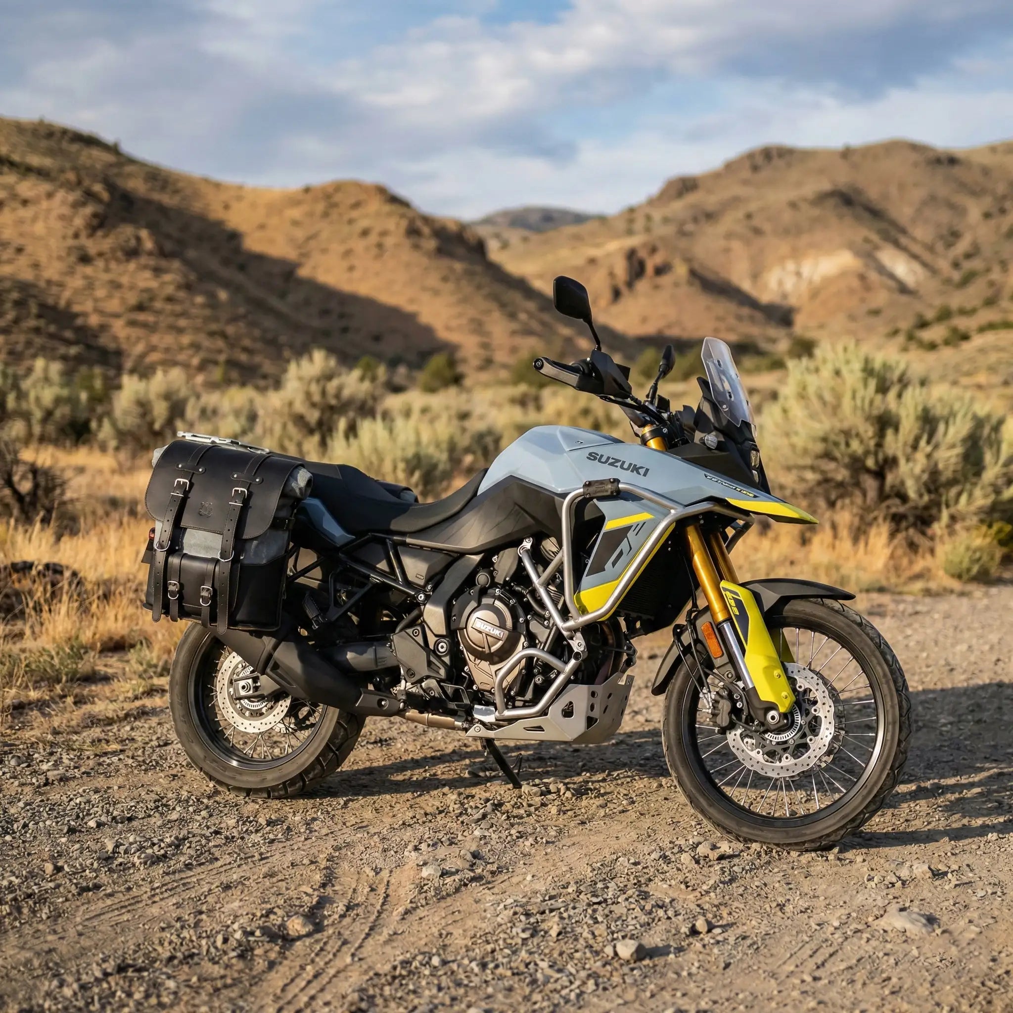 Suzuki V-Strom motorcycle with saddlebags on a desert landscape
