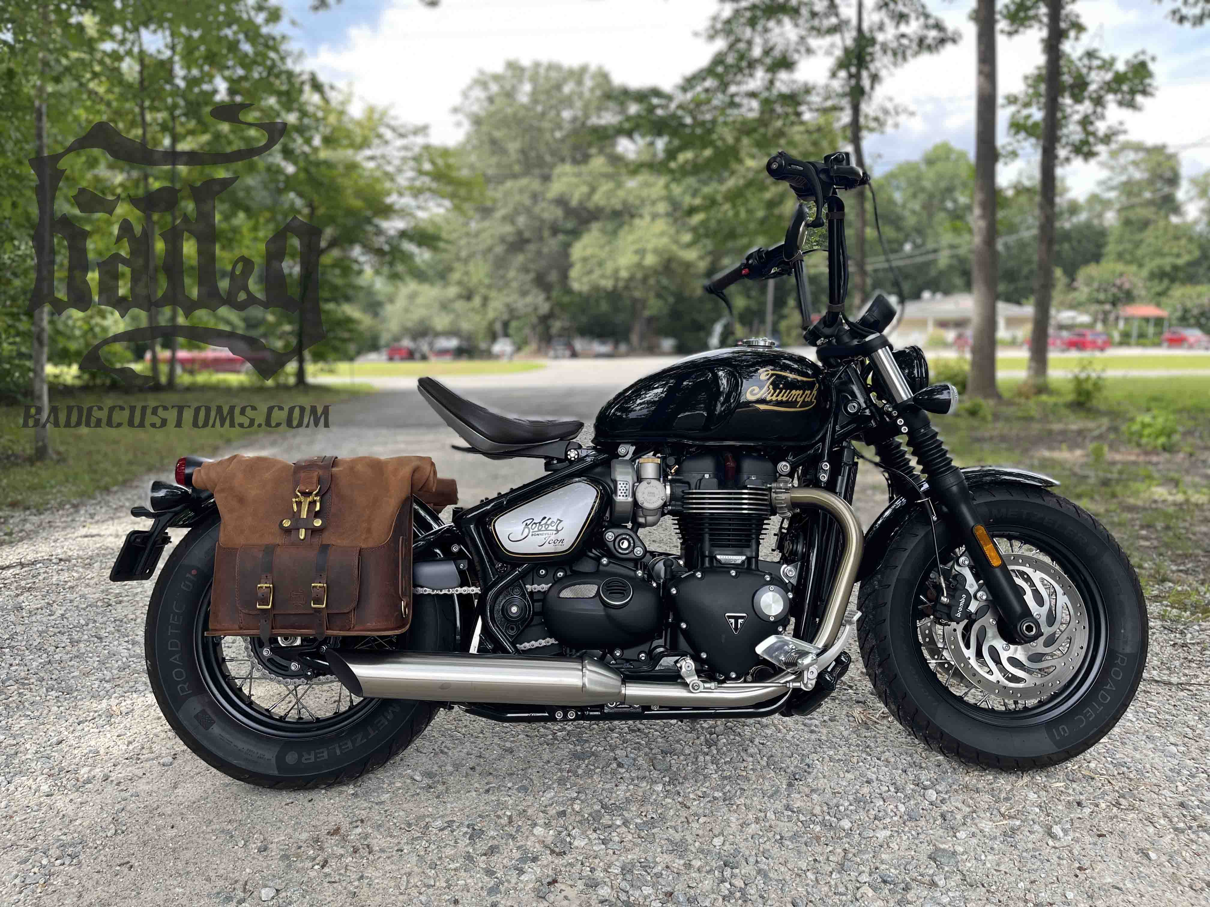 Triumph Bonneville Bobber Panniers Rolltop Swingarm Saddlebags. Hand crafted in USA with premium veg tan water buffalo leather, waterproof liners and solid brass hardware. BAD&G Customs TBP01