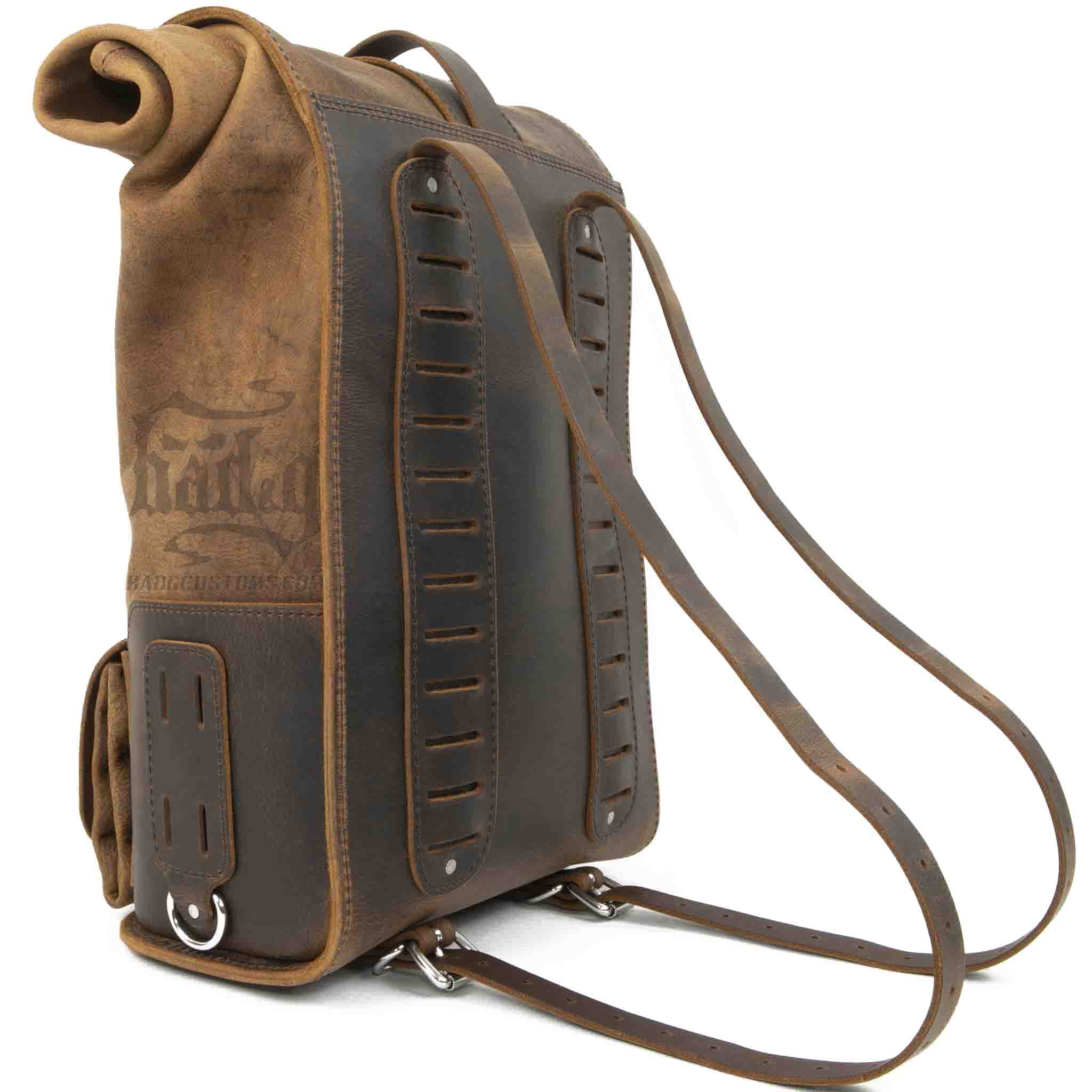 Upgrade your ride with the URB01 Rolltop Backpack Saddlebag. Unique design enables quick conversion from saddlebag to backpack. Hand crafted in USA with premium veg tan water buffalo leather and stainless steel hardware. Durable and stylish, it's the perfect fit for your motorcycle.
