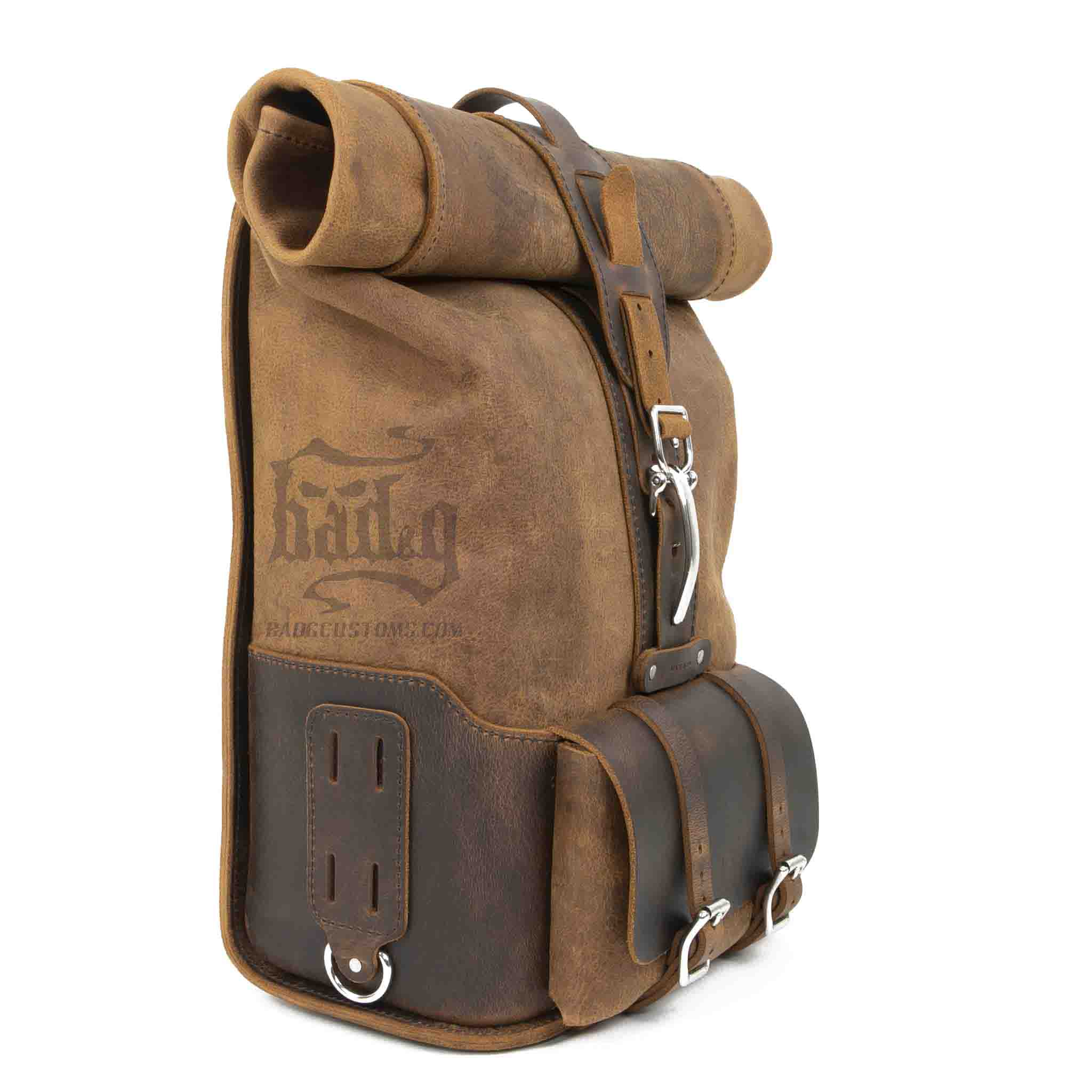 Upgrade your ride with the URB01 Rolltop Backpack Saddlebag. Unique design enables quick conversion from saddlebag to backpack. Hand crafted in USA with premium veg tan water buffalo leather and stainless steel hardware. Durable and stylish, it's the perfect fit for your motorcycle.