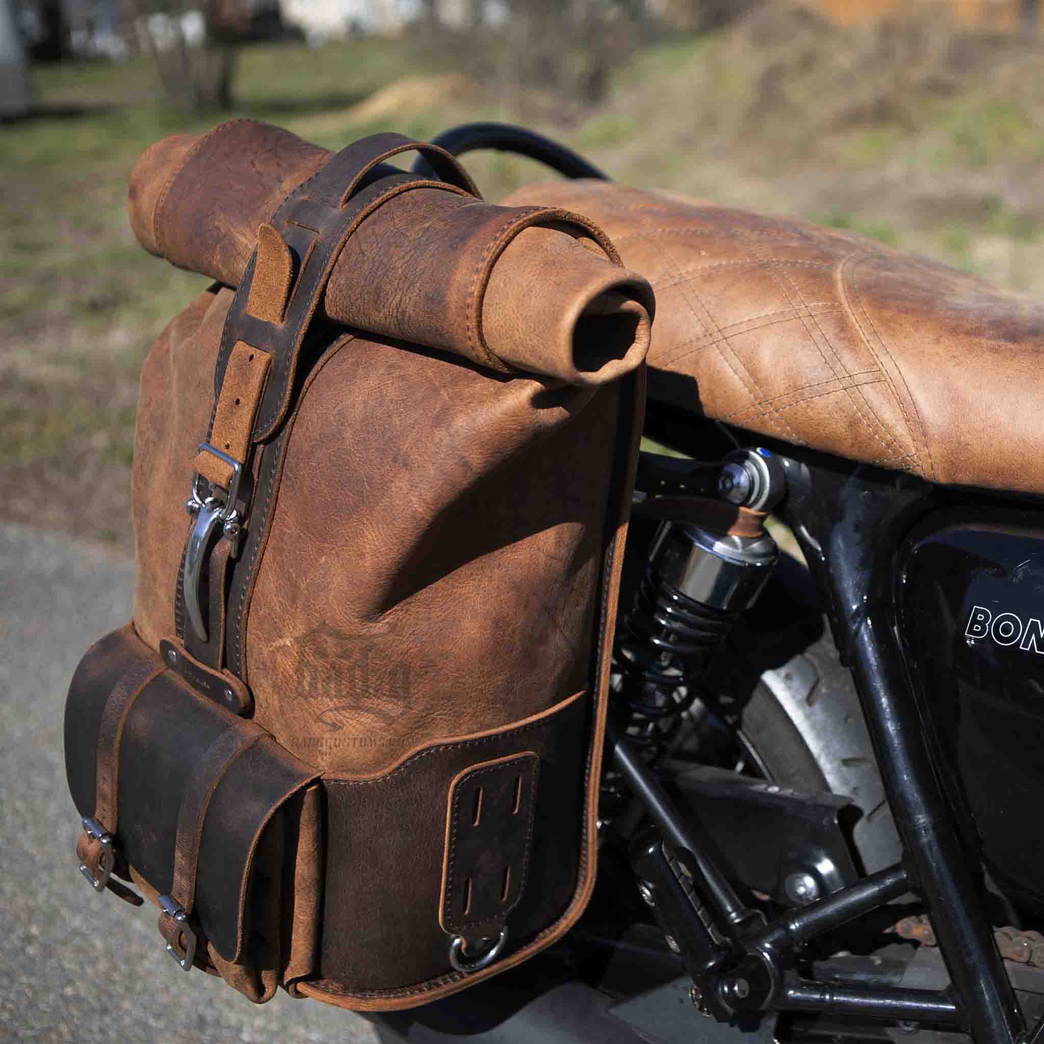Upgrade your ride with the URB01 Rolltop Backpack Saddlebag. Unique design enables quick conversion from saddlebag to backpack. Hand crafted in USA with premium veg tan water buffalo leather and stainless steel hardware. Durable and stylish, it's the perfect fit for your motorcycle.