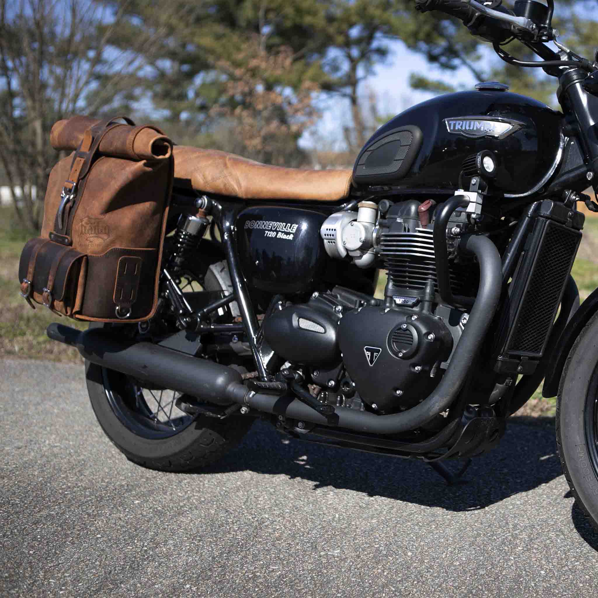 Upgrade your ride with the URB01 Rolltop Backpack Saddlebag. Unique design enables quick conversion from saddlebag to backpack. Hand crafted in USA with premium veg tan water buffalo leather and stainless steel hardware. Durable and stylish, it's the perfect fit for your motorcycle.