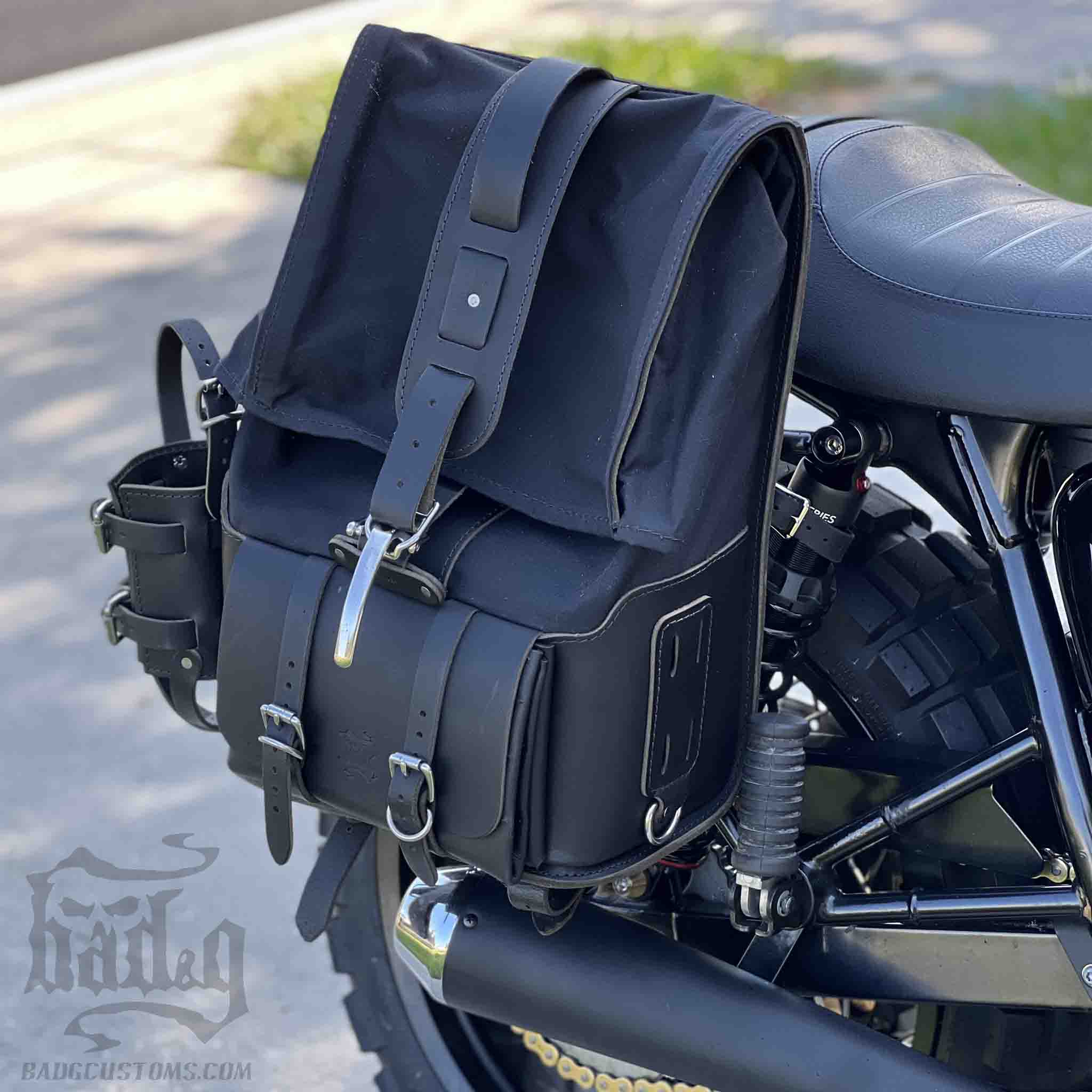 Upgrade your ride with the URB03 Rolltop Backpack Saddlebag. Unique design enables quick conversion from saddlebag to backpack. Hand crafted in USA with premium veg tan water buffalo leather, waxed canvas and stainless steel hardware. Durable and stylish, it's the perfect fit for your motorcycle.